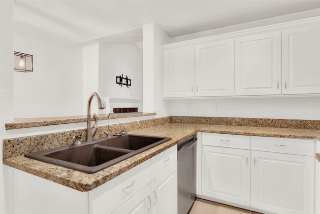 Kitchen with dishwasher and white cabinetry | Image 11