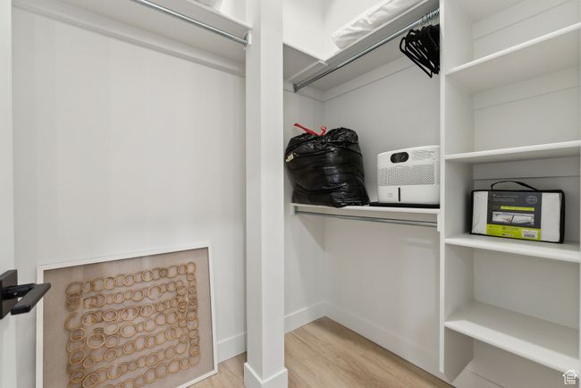 Spacious closet featuring light wood-type flooring | Image 22