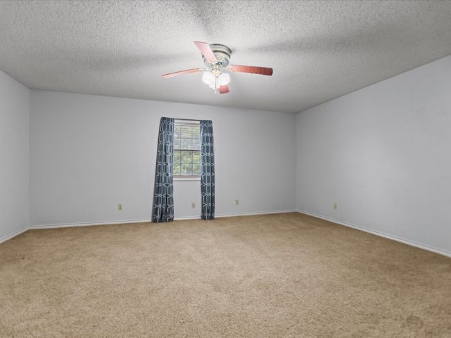 Bedroom 2 - Carpeted spare room with ceiling fan, a textured ceiling, and baseboards | Image 29