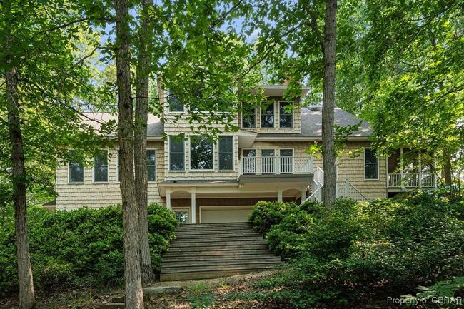 View of front facade with roof with shingles, a garage, and stairs | Image 4