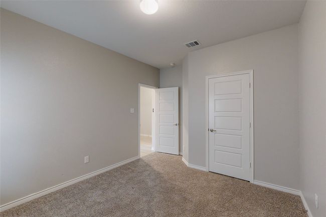 Unfurnished bedroom featuring visible vents, baseboards, and light carpet | Image 29