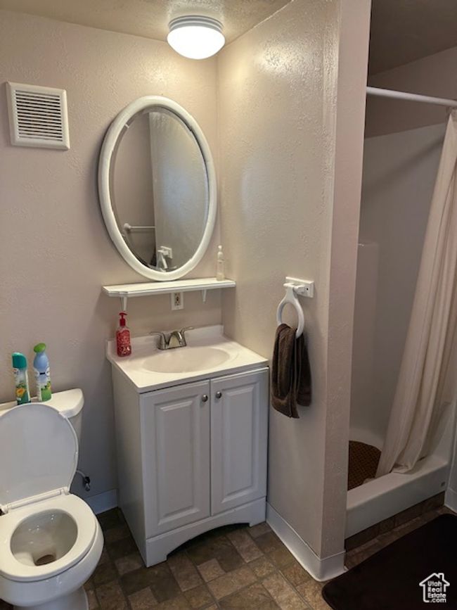 Bathroom with toilet, a stall shower, baseboards, and visible vents | Image 21