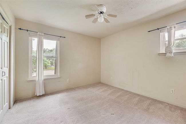 Spare room featuring light carpet, a ceiling fan, and baseboards | Image 20