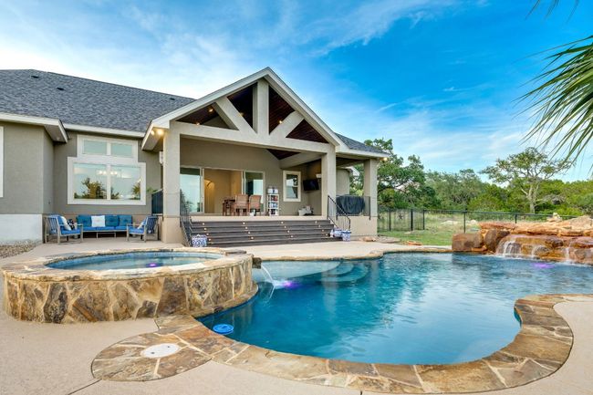 View of swimming pool with an outdoor hangout area, a pool with connected hot tub, and a patio | Image 29