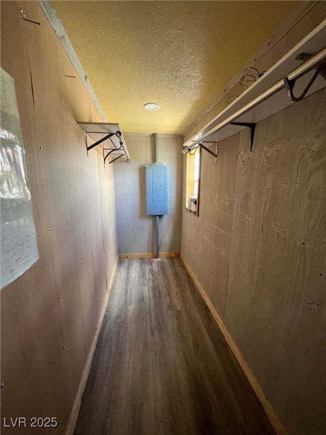 Basement with a textured ceiling, baseboards, and wood finished floors | Image 8