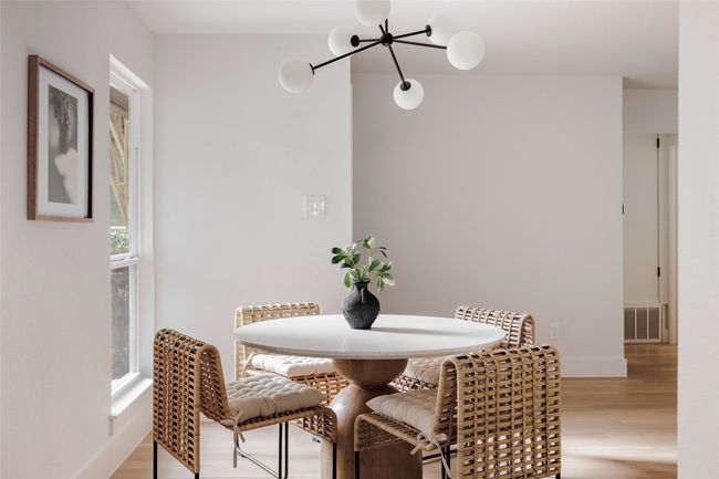 Dining area with wood finished floors and a chandelier | Image 6
