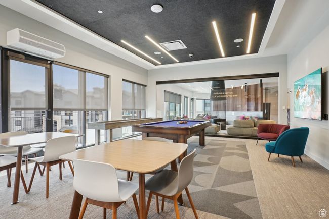 Rec room with a healthy amount of sunlight, a wall unit AC, visible vents, and pool table | Image 32
