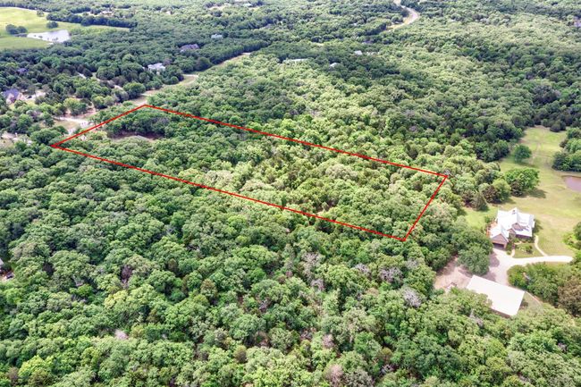 Aerial view of property's location featuring a forest and property parcel outlined | Image 37