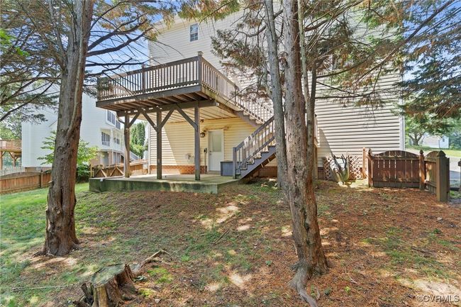View of yard featuring a deck, stairway, and a patio area | Image 32