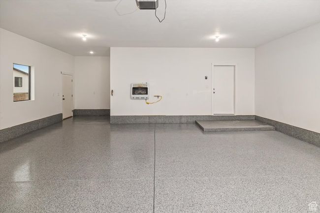 Garage featuring heating unit and a garage door opener | Image 43