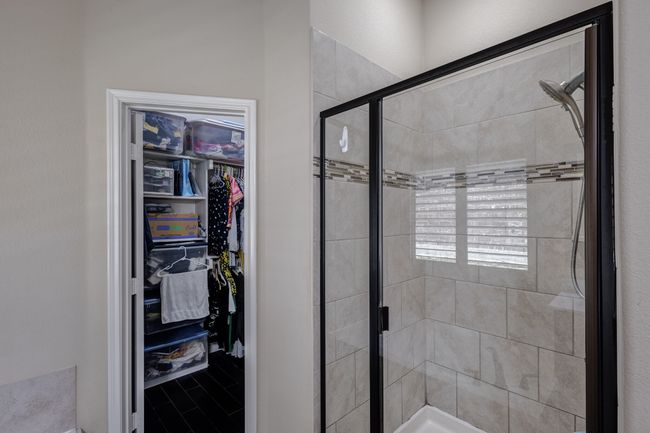 Full bathroom with a stall shower and a walk in closet | Image 26