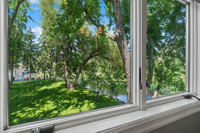 Water and yard views from an upstairs bedroom | Image 17