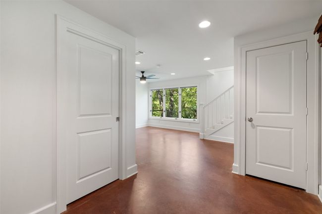 Corridor featuring concrete floors, visible vents, recessed lighting, stairs, and baseboards | Image 26