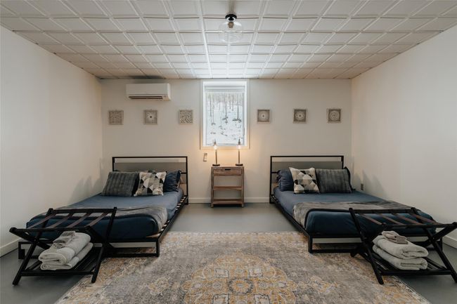 Basement room with a wall mounted air conditioner | Image 26