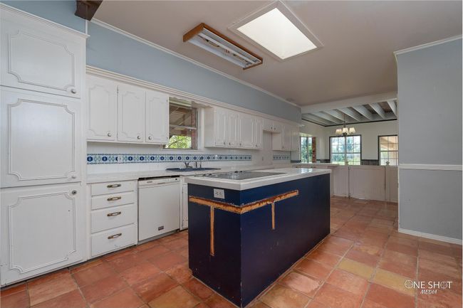 Kitchen with dishwasher, tasteful backsplash, white cabinets, a kitchen island, and crown molding | Image 9