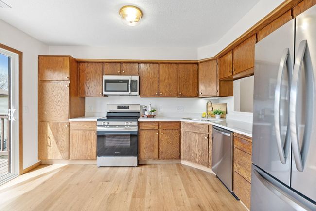 Ample storage, new cabinet pulls, and faucet, quartz countertops, and modern stainless steel appliances make this kitchen a stand out. | Image 9