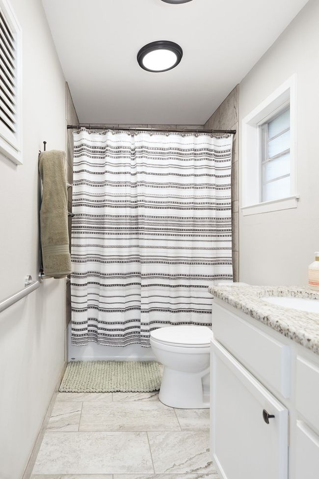 Full bath with toilet, vanity, and shower / bath combination with curtain | Image 21
