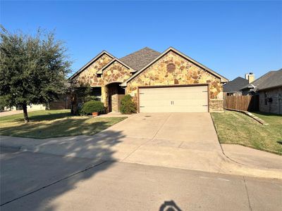 View of front of home featuring a garage and a front lawn | Image 1