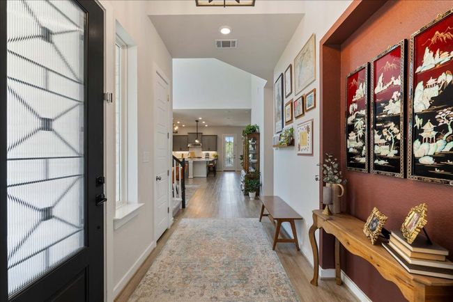 Entryway featuring light wood finished floors, visible vents, and baseboards | Image 4