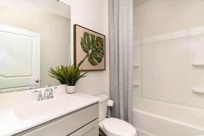 Full bath featuring shower / tub combo, vanity, and toilet | Image 19