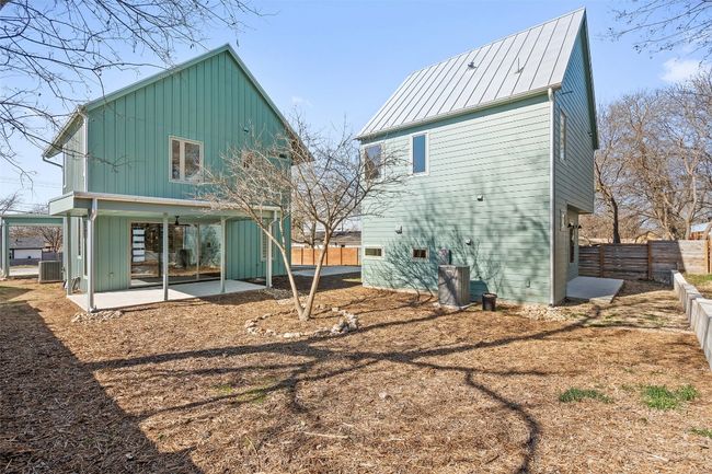 Rear view of property with a patio, a standing seam roof, central AC, metal roof, and a fenced backyard | Image 20