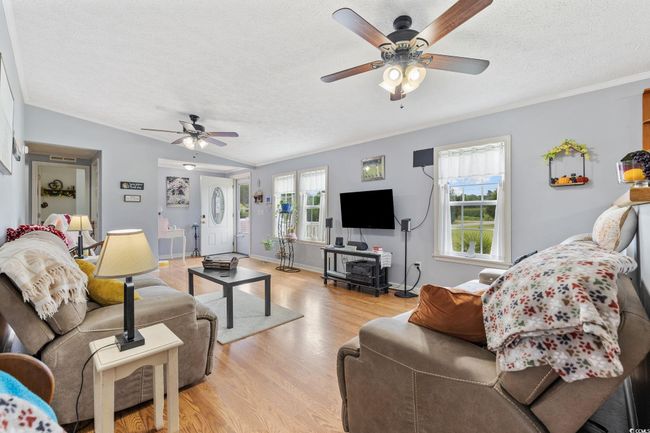 Entrance foyer with light wood-style floors, ornamental molding, and a textured ceiling | Image 6