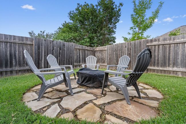 Fenced backyard featuring a patio and an outdoor fire pit | Image 36