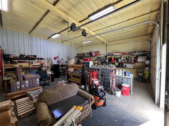 Garage with metal wall and a workshop area | Image 34