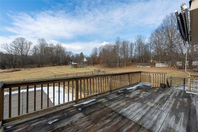 View of swimming pool with a patio | Image 35