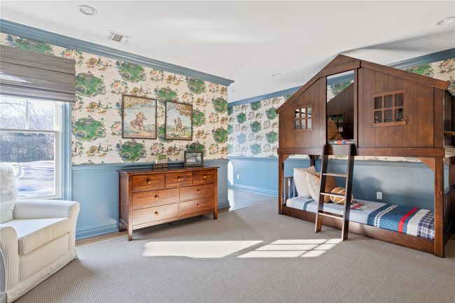 Carpeted bedroom with wainscoting, wallpapered walls, visible vents, and ornamental molding | Image 35