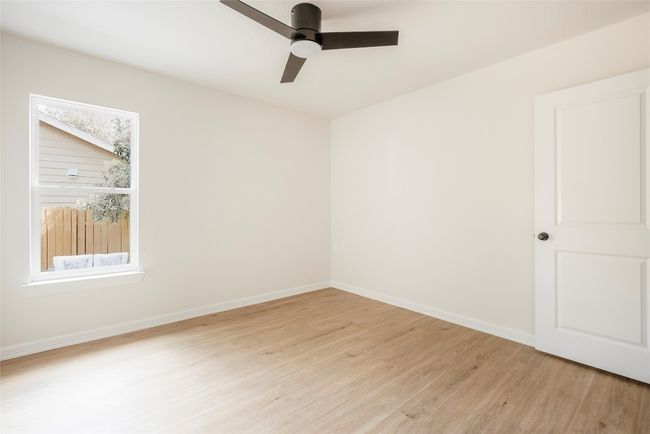Empty room featuring light wood-style flooring and a ceiling fan | Image 25