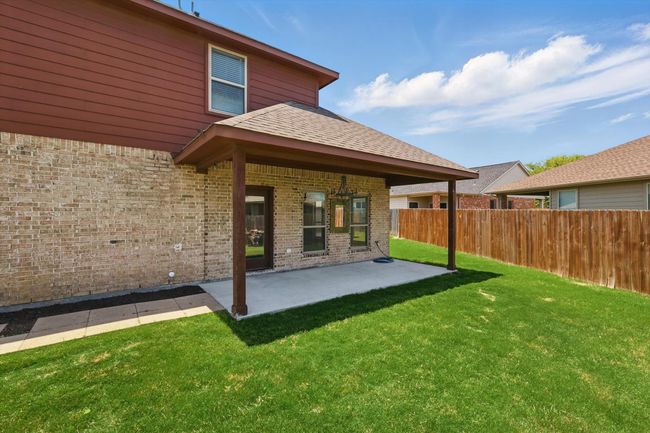 Back of house featuring brick siding and a patio | Image 36