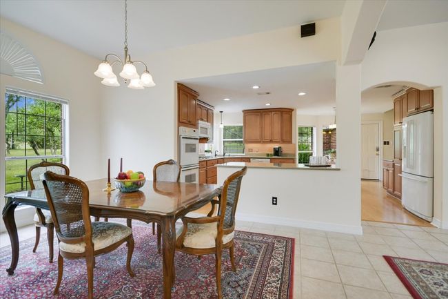 The formal dining room offers an elegant setting for hosting dinners and special occasions. | Image 10