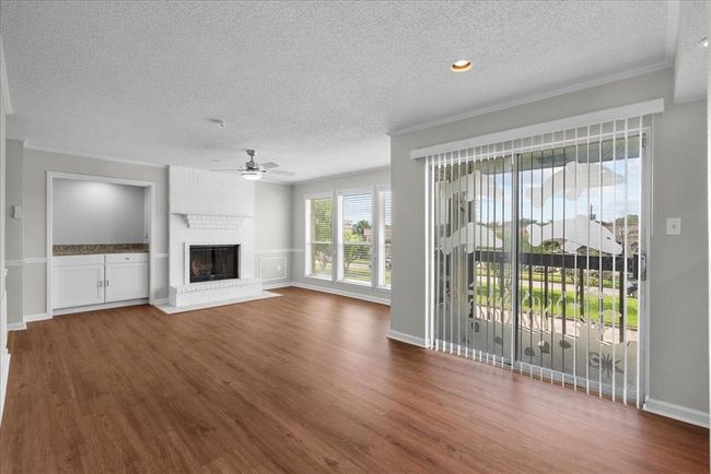 Open to the kitchen, full of sunshine, and serving serious fireplace goals. Add a dry bar? Perfection! | Image 7