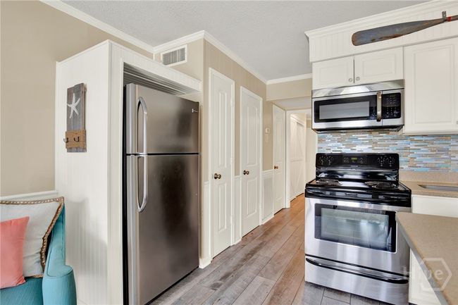 Full Sized Kitchen with Stainless Steel Appliances, Ceiling Height Cabinets, Island with Barstool Seating & Pantry. | Image 10