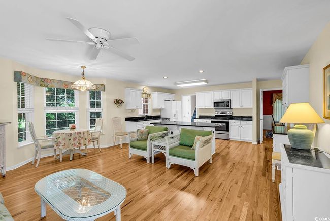 Living room with light wood-style floors, ceiling fan, and recessed lighting | Image 20