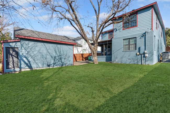 Rear view of property with a yard and central AC unit | Image 30