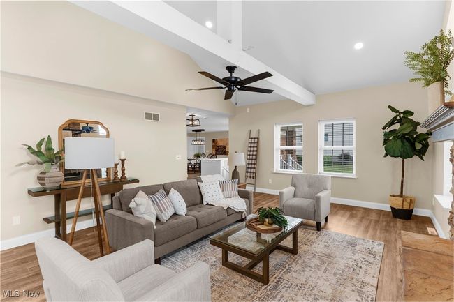 Living area featuring wood finished floors, a ceiling fan, and recessed lighting | Image 14