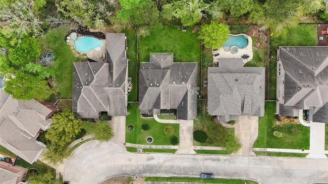 This aerial view highlights the home's prime location with a generous backyard, mature trees, and no rear neighbors for added privacy. Enjoy a peaceful setting in a beautifully maintained community with great curb appeal and convenient access to nearby amenities. | Image 39