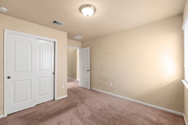 Unfurnished bedroom with a closet, carpet, visible vents, and baseboards | Image 14