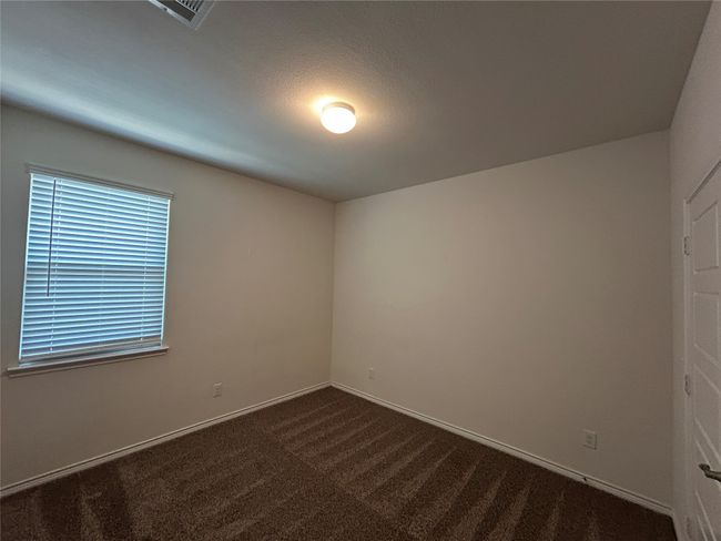 Empty room featuring dark carpet and baseboards | Image 20