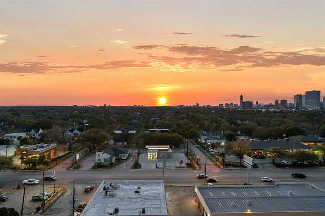 Breathtaking sunset views from the primary suite, showcasing the skyline and vibrant neighborhood below. | Image 18
