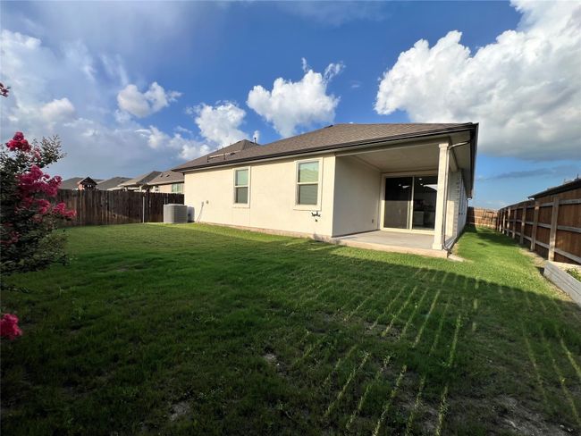 Rear view of house featuring a patio, stucco siding, and a fenced backyard | Image 13