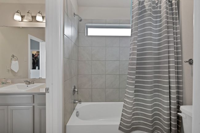 Bathroom with toilet, vanity, and shower / tub combo | Image 30