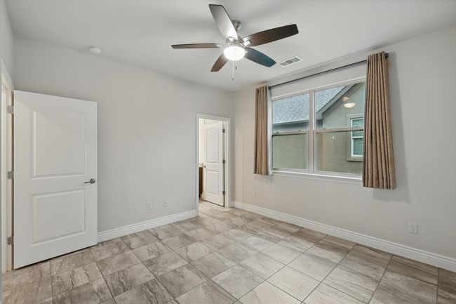 2nd Bedroom with ceiling fan and tile floors - ensuite bath | Image 19