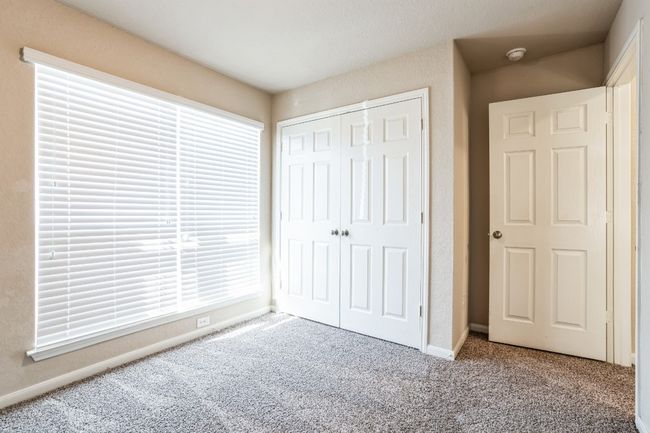 Unfurnished bedroom with light colored carpet and a closet | Image 16