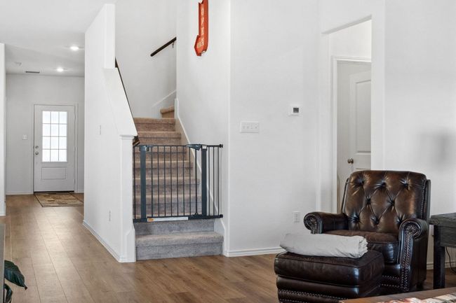 Sitting room with baseboards, stairway, wood finished floors, and recessed lighting | Image 7