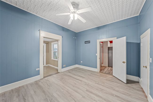 Spare room featuring light wood-type flooring and ceiling fan | Image 19