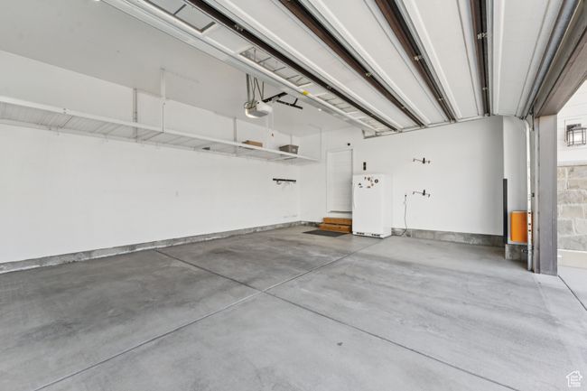Garage with a garage door opener and refrigerator | Image 39