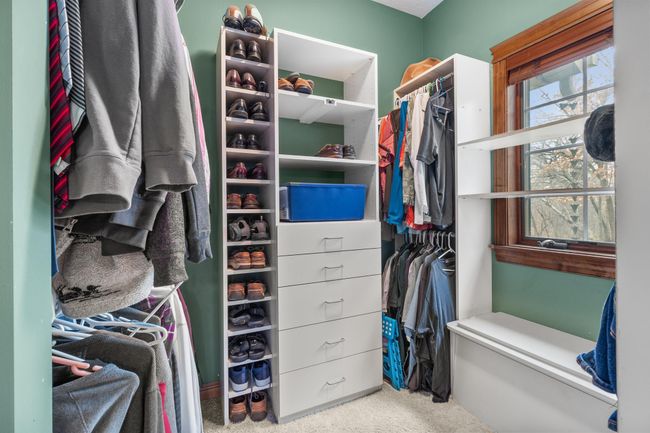 Primary bedroom suite second walk in closet off primary bath. Built-in storage and hanging space. | Image 28
